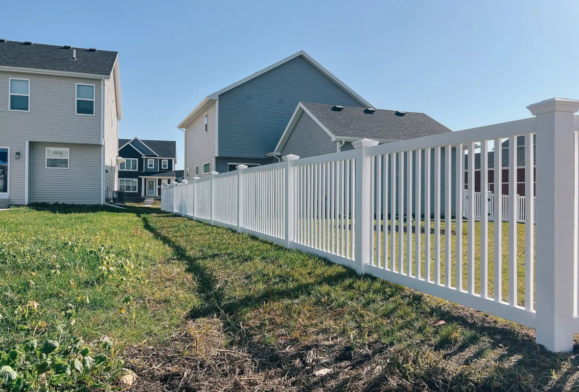 White vinyl picket fence installation by professional contractors